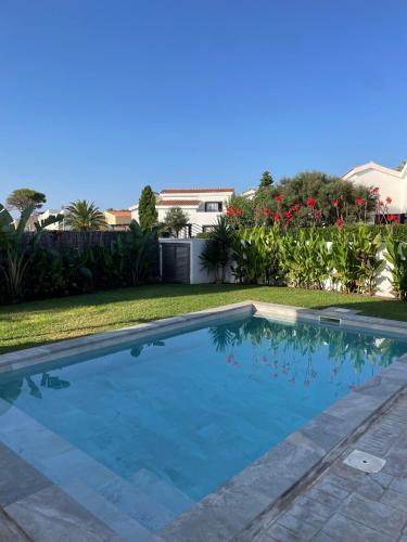 a swimming pool in the yard of a house at Villa d’Aina * Propiedad privada con piscina in Cala'n Bosch