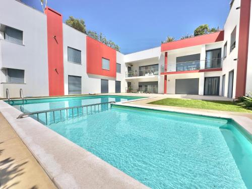 a swimming pool in front of a building at Secret Spot Baleal - Luxury Flat in Ferrel