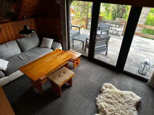 a living room with a couch and a table at Hájská chata in Teplice