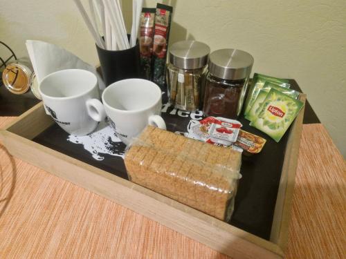 a tray with two cups and some food on a table at Vivari apartment in Vivari