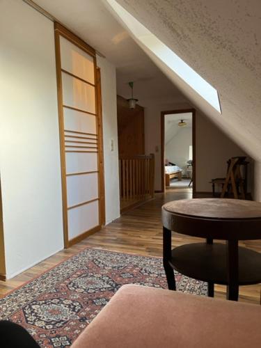 a living room with a table and a rug at Kirchhof in Dobis