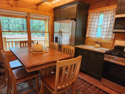 a kitchen with a wooden table with a pumpkin on it at Three bears lodge in Gatlinburg