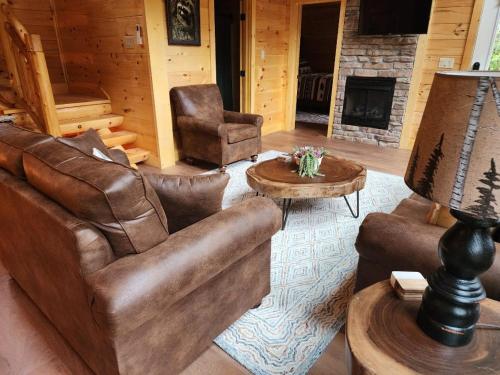 a living room with leather furniture and a fireplace at Three bears lodge in Gatlinburg