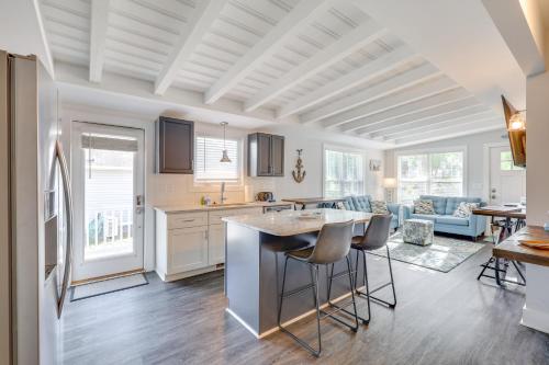 a kitchen and living room with a table and chairs at Modern Oak Island Escape 1 Mile to Long Beach! in Oak Island