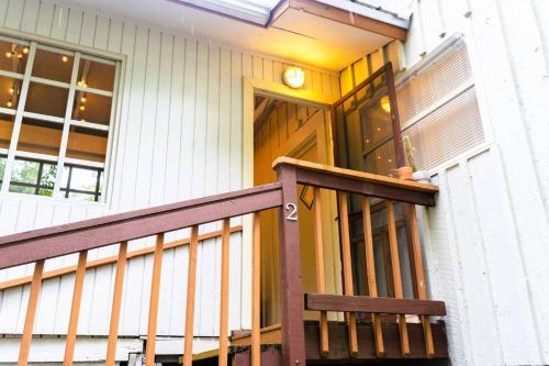 a house with a porch with a wooden door at Summer House - 1Br-1Ba - Second Floor Apt - Five Minute Walk To City Gates in St. Augustine