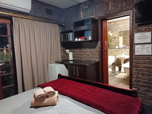 a bedroom with a bed with two towels on it at Royal Game Guest House in Phalaborwa