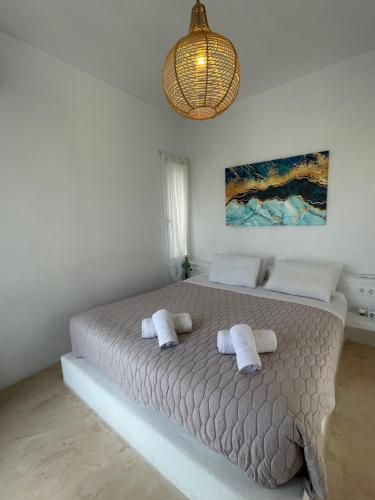 a bedroom with a large bed with towels on it at The Velanidies - Οι Βελανιδιές in Agia Marina
