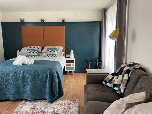 a bedroom with a bed and a couch at Riverbank Studios in Westport