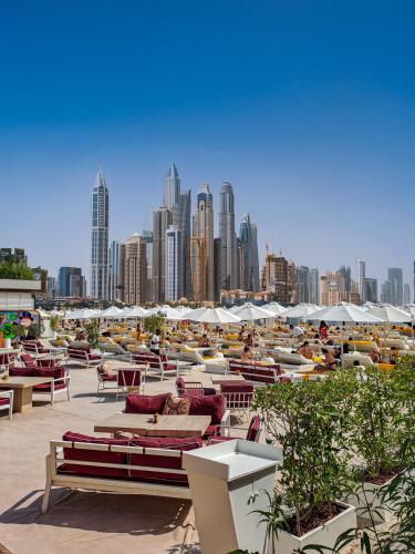 a group of tables and chairs with a city skyline at FIVE Palm Jumeirah Premier Apartments in Dubai