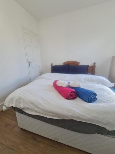 a bed with two pillows on top of it at The Oaks in Grays Thurrock