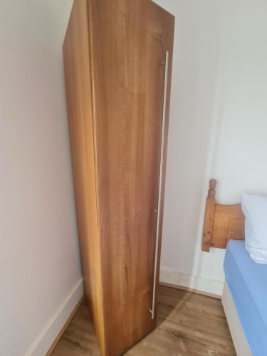 a wooden door in a corner of a room at The Oaks in Grays Thurrock