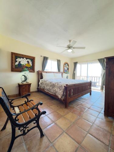a bedroom with a bed and a bench in it at El Ojo del Mar - Las Conchas in Puerto Peñasco