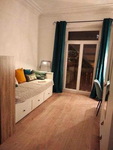 une chambre avec un lit et une grande fenêtre dans l'établissement Appartement climatisé près centre, à Toulon