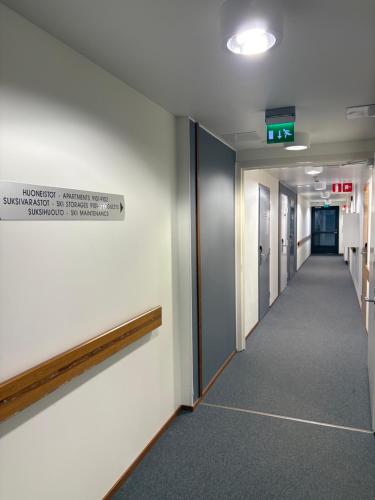 a hallway in an office building with a sign on the wall at Ylläs Chalet 9212 in Ylläsjärvi