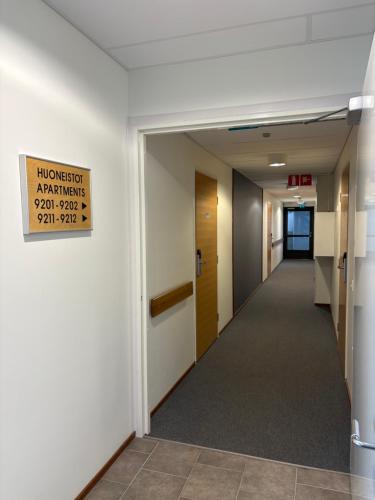 a hallway in an office building with a sign on the wall at Ylläs Chalet 9212 in Ylläsjärvi