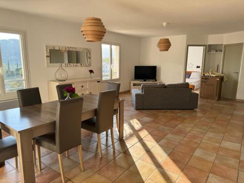 un salon avec une table à manger et un canapé dans l'établissement Hébergement à la campagne, à Évenos