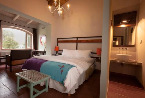a bedroom with a large bed and a sink at Hotel Huacalera in Huacalera