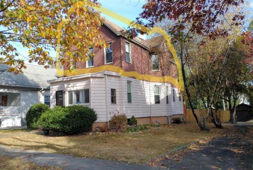 a brown and white house with a tree at Comfortable 3 Bedroom Apartment 30 Minutes to New York in Pfister Helistop