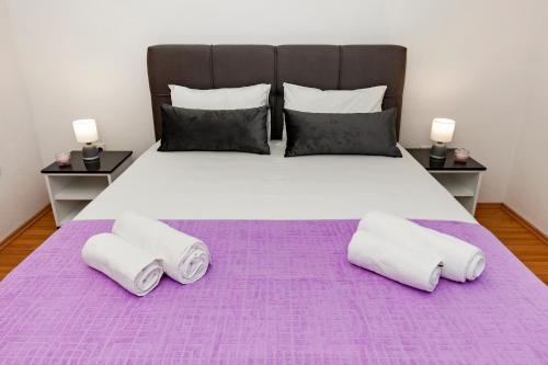 a bedroom with a large bed with two pillows at Boris & Matej Apartments in Ohrid