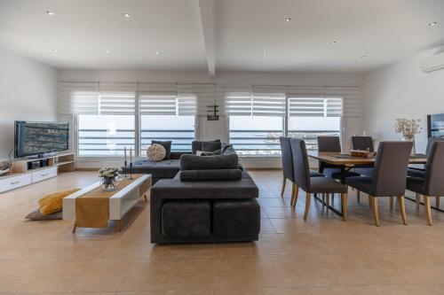 a living room with a couch and a table at Villa Stavros in Archangelos