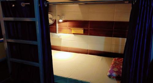 a bunk bed with a light in a room at The Street homestay in Agra