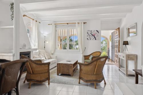 a living room with a couch and a table and chairs at Nuestra Casa in Denia