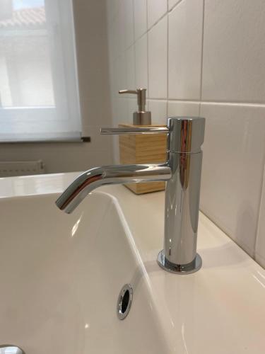 a kitchen sink with a chrome kitchen faucet at Affittacamere Torrione in Venzone
