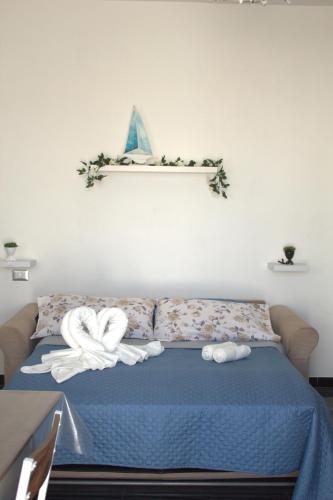 a bedroom with a bed with towels on it at D&C House in Galatone