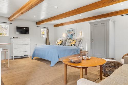 a bedroom with a bed and a table at Solbjerggaard Bed & Breakfast in Fåborg