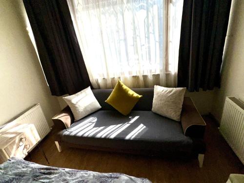 a couch sitting in a room with a window at Center Hotel Two in Istanbul