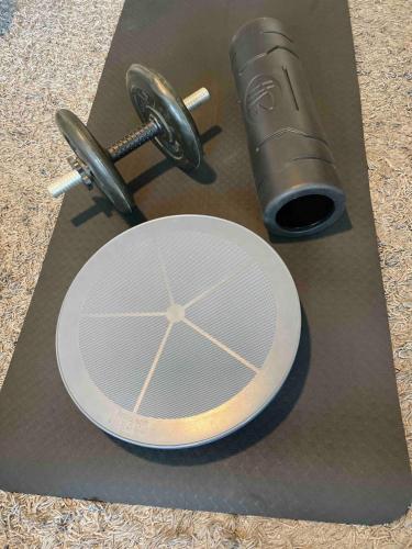 a table topped with a plate and a metal cylinder at Wonderful Love Studio - whole city within reach in Helsinki