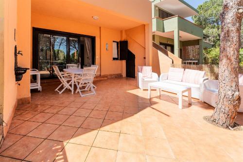 a patio with white furniture and a table and chairs at Casa Mimose, 200m to beach in Pula