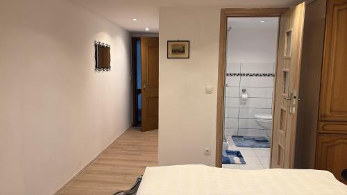 a bedroom with a bed and a bathroom with a toilet at Villa EDEN BLICK in Edenkoben