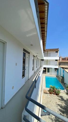 an external view of a house with a swimming pool at Hospedaje Rio Hotels Mancora in Máncora
