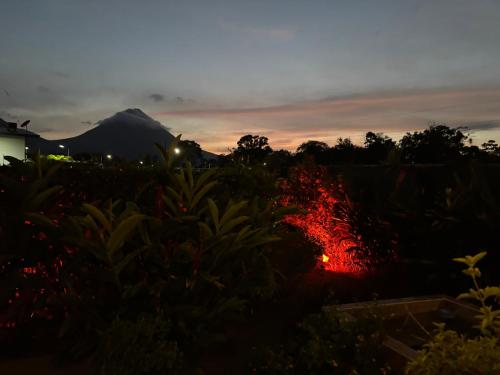 a view of the sunset from our garden at La fortuna cabañas Kwepal vista al volcan Arenal in Fortuna