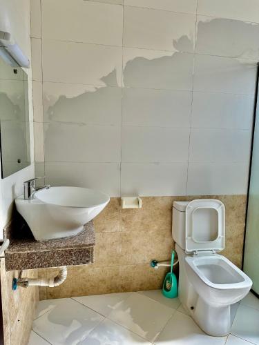 a bathroom with a sink and a toilet at Clalem Condos Diani Beach in Diani Beach