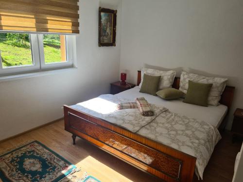 a bedroom with a bed in a room with a window at Apartmani Podvisoki in Visoko