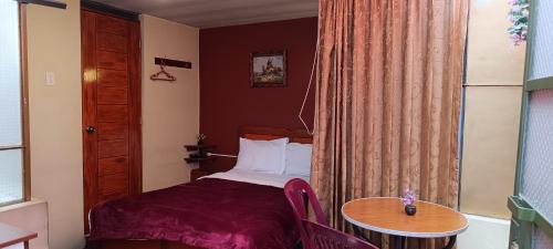 Postel nebo postele na pokoji v ubytování Hostal Sumak'usi