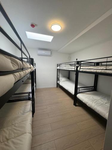 a room with three bunk beds and a light at Y Hostel in Amsterdam
