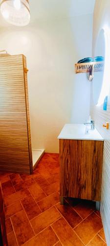 a bathroom with a sink and a shower at La Barbería de Miguel in El Chorro