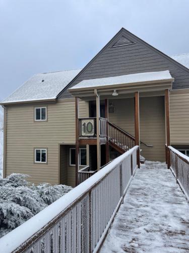 a house with a snow covered walkway in front of it at Sugar Ski & Country Club in Sugar Mountain