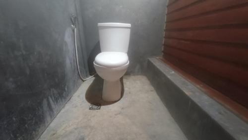a bathroom with a white toilet in a stall at Pondok Elen Mandalika 001 in Praya