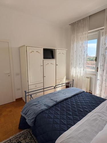 a bedroom with a bed and a large window at Adriatico 98 in Fano
