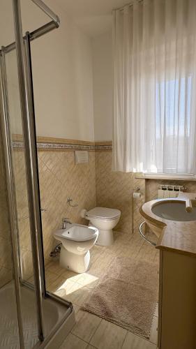 a bathroom with a toilet and a sink and a tub at Adriatico 98 in Fano