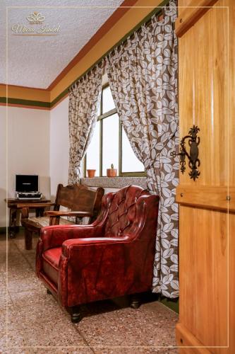a living room with a couch and a window at Quinta maría isabel. Elegante y restaurada in Gualaceo