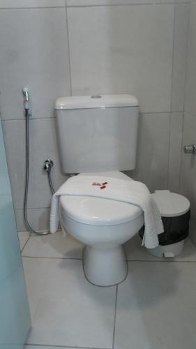 a bathroom with a toilet with a towel on it at Hotel Saveiro in Recife