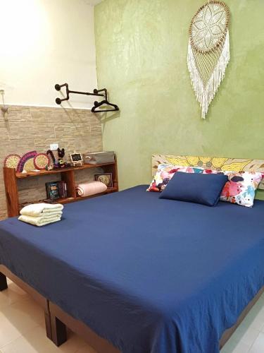 a bedroom with a blue bed in a room at Casa Candelita in Valladolid
