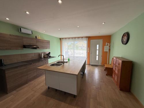 a kitchen with a island in the middle of a room at Completely renovated house in Heuilley-le-Grand