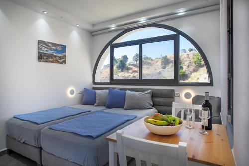 a bedroom with a bed and a table with a bowl of fruit at פינת הקסם in Safed