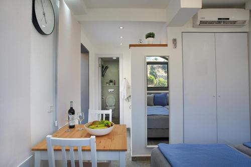 a kitchen and dining room with a table and a clock at פינת הקסם in Safed